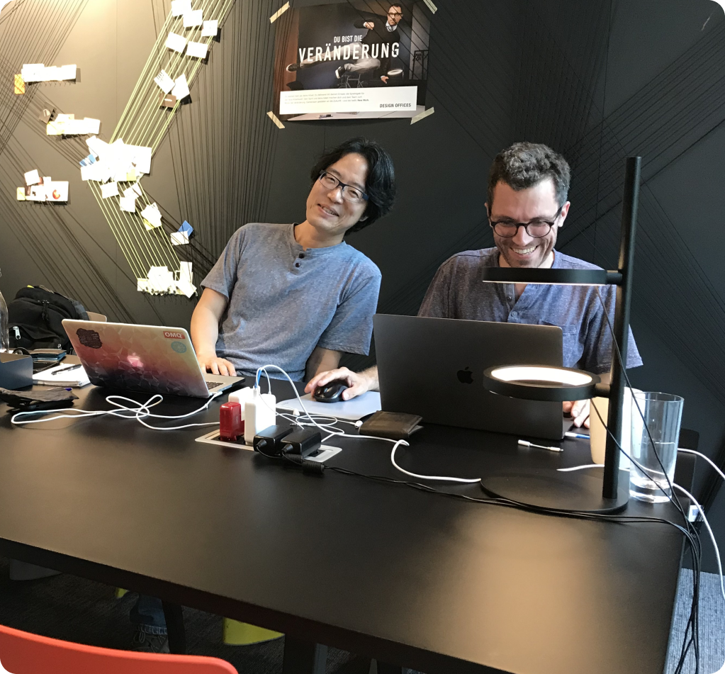 Matthias and Gil sitting at a desk